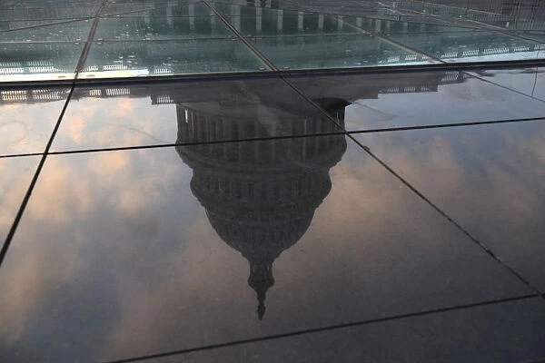 The U. S. Capitol building is seen in a reflection on Capitol Hill in Washington