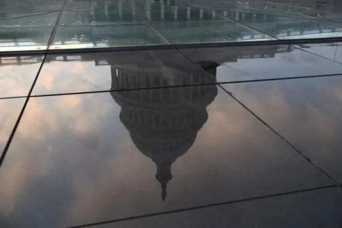 Framed Print : The U. S. Capitol building is seen in a reflection on Capitol Hill in Washington