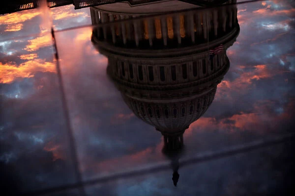 The U. S. Capitol dome is reflected in the glass skylight of the Capitol Visitor Center