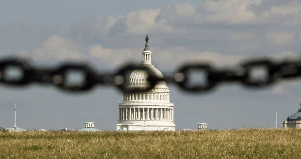 U. S. Capitol is photographed behind a chain fence in Washington