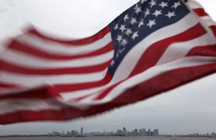 Framed Print : A U. S. flag flutters over top of the skyline of New York and Jersey City Framed Print : A U. S. flag flutters over top of the skyline of New York and Jersey City