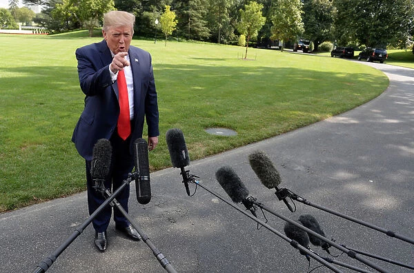 U. S. President Donald Trump speaks to the media before departing the White House