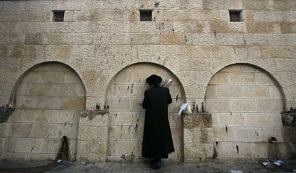 An ultra-Orthodox Jewish man prays outside Rachels Tomb in the West Bank town of