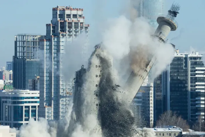 Framed Print : The unfinished and abandoned TV tower collapses during a controlled demolition in Framed Print : The unfinished and abandoned TV tower collapses during a controlled demolition in
