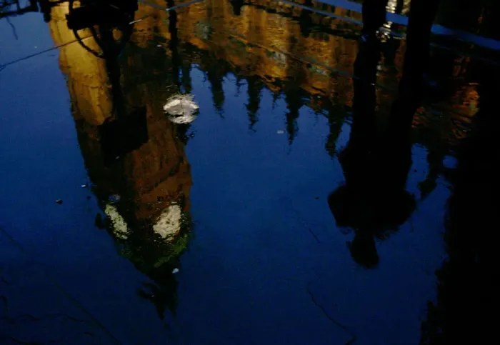 Framed Print : An unidentified Member of Parliament is reflected in a puddle as he hurries into Framed Print : An unidentified Member of Parliament is reflected in a puddle as he hurries into