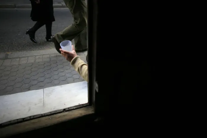 Framed Print : A vagrant begs at the entrance of a church in the Andalusian capital of Seville