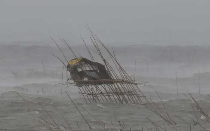 Framed Print : A view of a fishermans house as it is pounded by waves