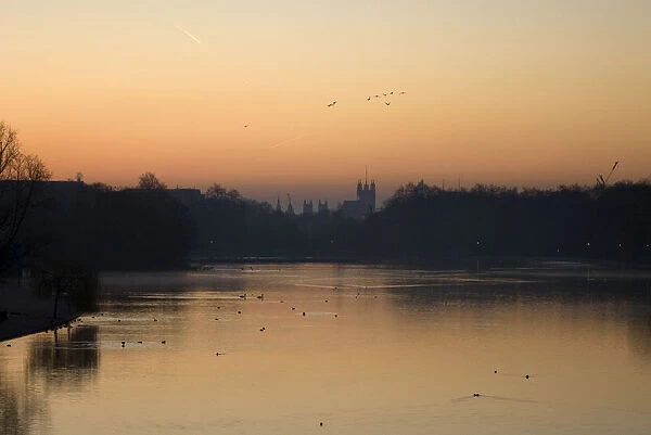 A view of the Houses of Parliament at sunrise from the Serpentine lake in Hyde Park