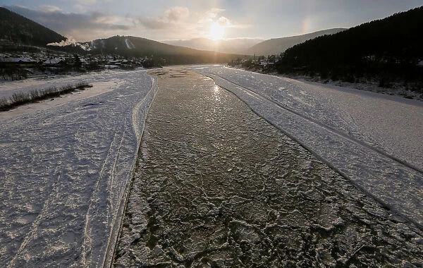 A view shows the Mana River, during an autumn ice drift at sunset