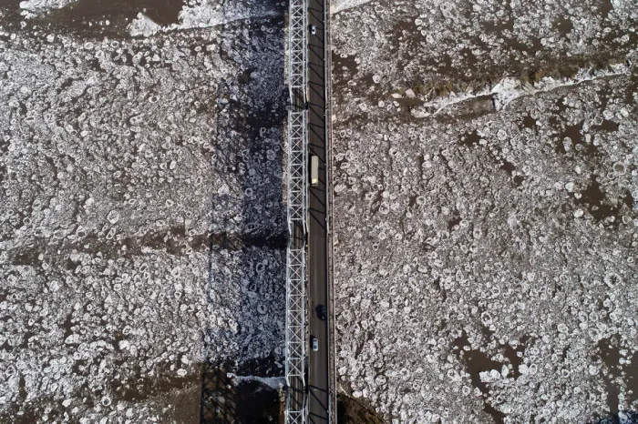 Framed Print : A view shows vehicles driving along a bridge across the Mana River during an ice drift Framed Print : A view shows vehicles driving along a bridge across the Mana River during an ice drift