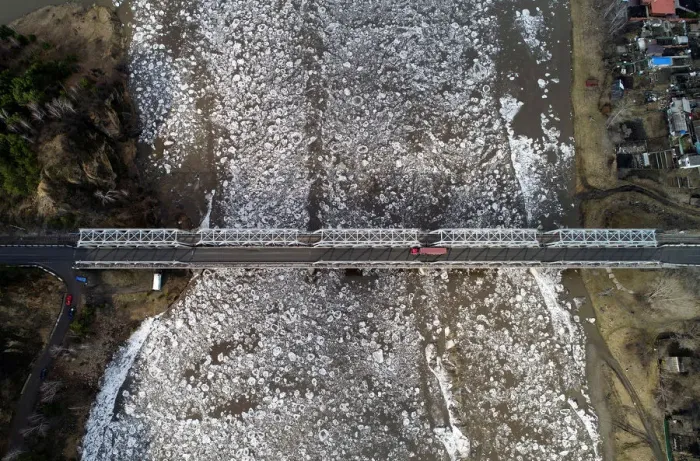 Framed Print : A view shows vehicles driving along a bridge across the Mana River during an ice drift Framed Print : A view shows vehicles driving along a bridge across the Mana River during an ice drift