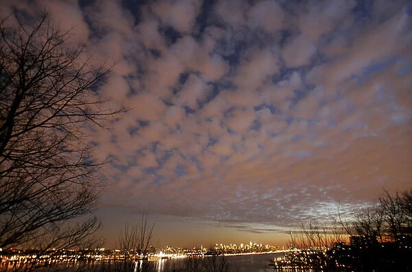 A view of storm clouds above New York City and the Hudson River at sunset