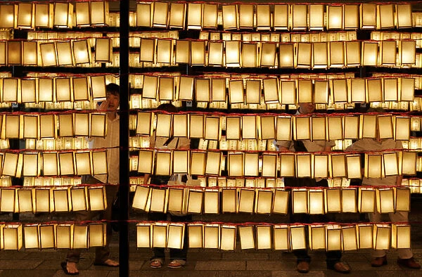 Visitors look at paper lanterns during Mitama Festival at Yasukuni Shrine in Tokyo