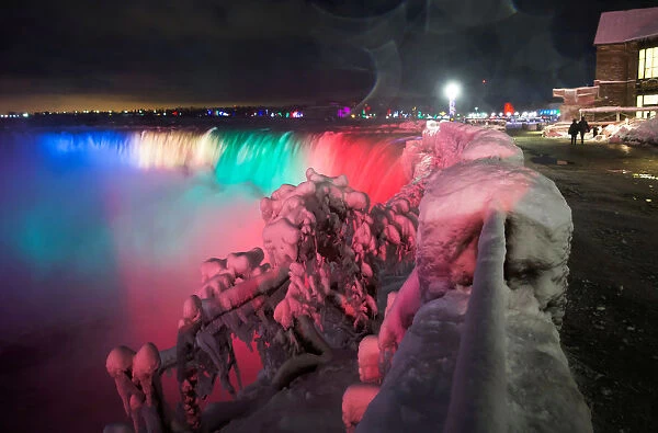 Visitors take pictures of ice covered Niagara Falls in Niagara
