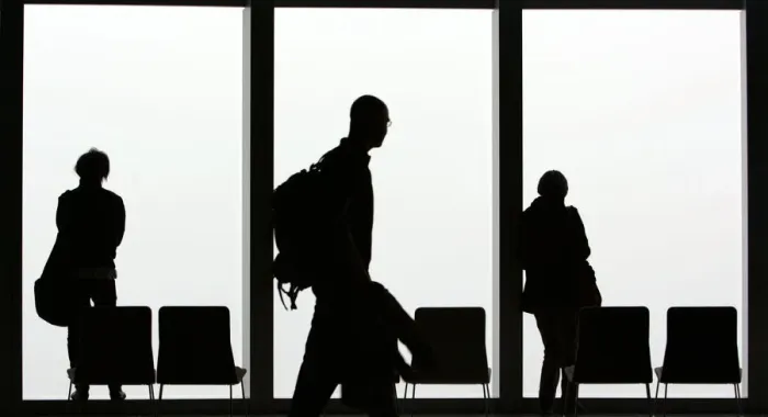 Framed Print : Visitors is silhouetted against a cloudy sky on the observation deck of a skyscraper