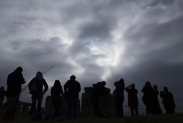 Visitors view the solar eclipse is seen over Stonehenge on Salisbury Plain, Salisbury