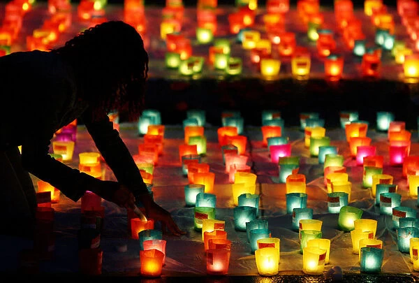 A volunteer sets up candles during Swiss national day in Berne