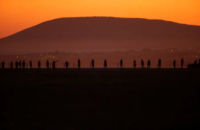 Framed Print : Volunteers wade across the lagoon at dawn to gather flamingo chicks and place them