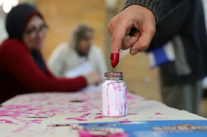 Framed Print : A voters finger is marked with ink at a polling station during the second day of