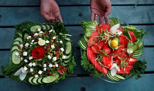 A waiter presents two types of salad served by Habibi restaurant in Peshawar