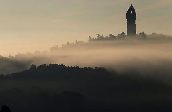 The Wallace Monument sits above the morning mist in Stirling, Scotland