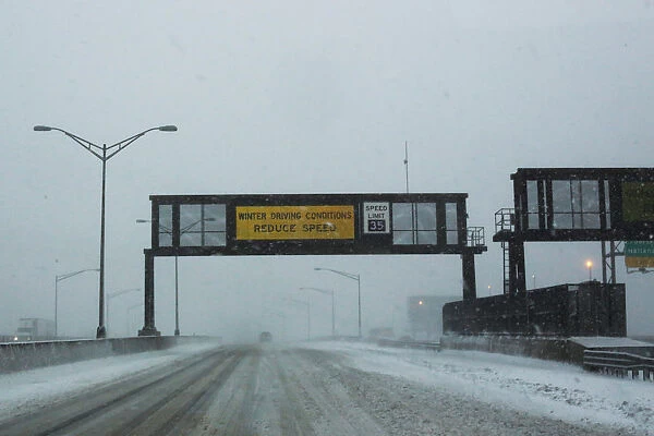 A warning alert is seen on a display as cars drive along the New Jersey Turnpike during a