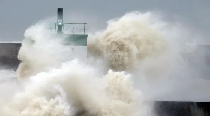 Framed Print : A wave breaks near the lighthouse in Biarritz, southwestern France