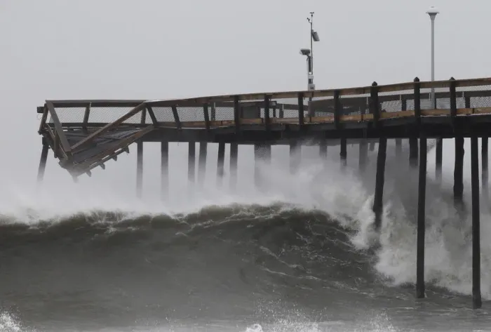 Framed Print : Waves break along the pier which was damaged during Hurricane Irene, in Ocean City