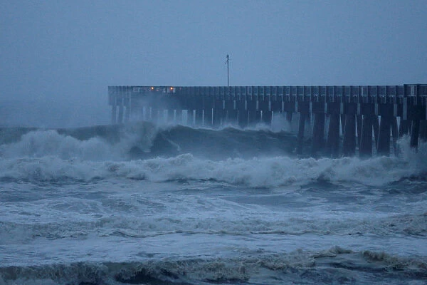 Waves crash along a pier as Hurricane Michael approaches Panama City Beach
