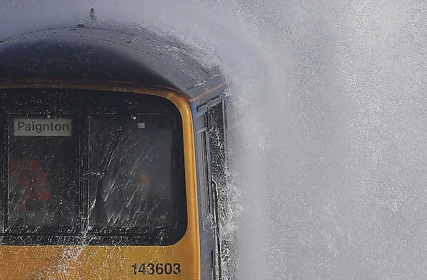 Waves hit a train during heavy seas and high winds in Dawlish in south west Britain