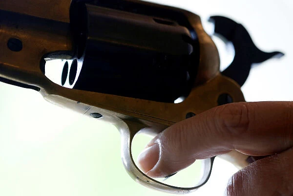 A weapon collector holds a 44 caliber gun in his house in Bordeaux