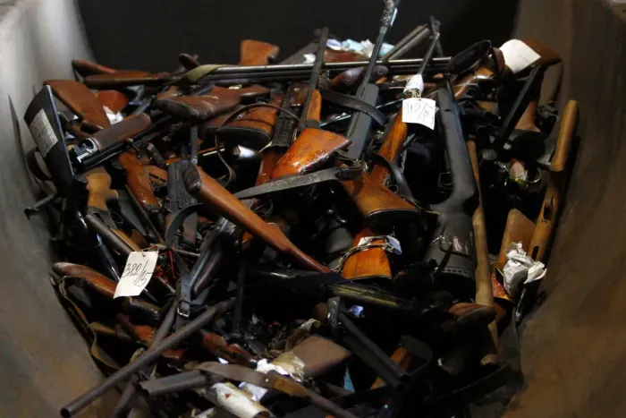 Framed Print : Weapons and drugs are displayed prior to their destruction in a melting nickel plant near