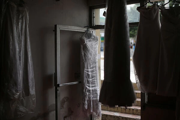 Wedding dresses hang on display for rent at a store in Port-au-Prince