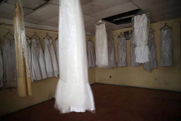 Wedding dresses hang on display for rent at a store in Port-au-Prince