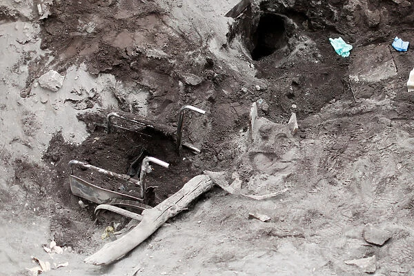 A wheelchair is seen buried, after rescuers searched for human remains at the house of