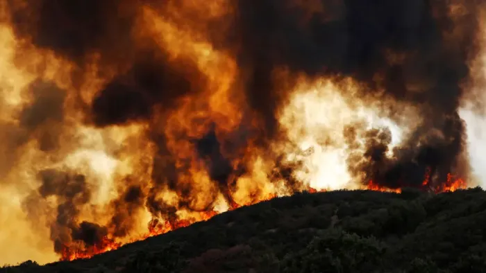 Framed Print : Wind-driven flames roll over a hill towards homes during the River Fire in Lakeport