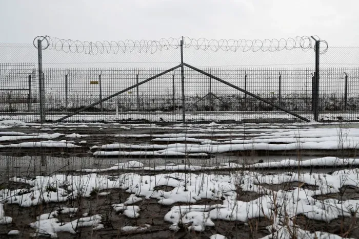 Framed Print : A wire fence is seen next to the village of Asotthalom Framed Print : A wire fence is seen next to the village of Asotthalom
