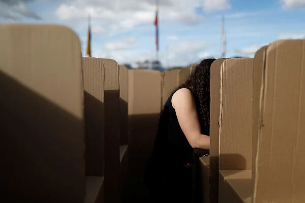A woman assembles voting booths ahead of the May 27 presidential election, in Bogota