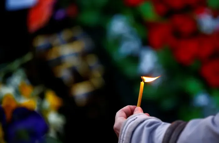 Framed Print : A woman holds a candle during an opposition rally to mark the anniversary of Framed Print : A woman holds a candle during an opposition rally to mark the anniversary of