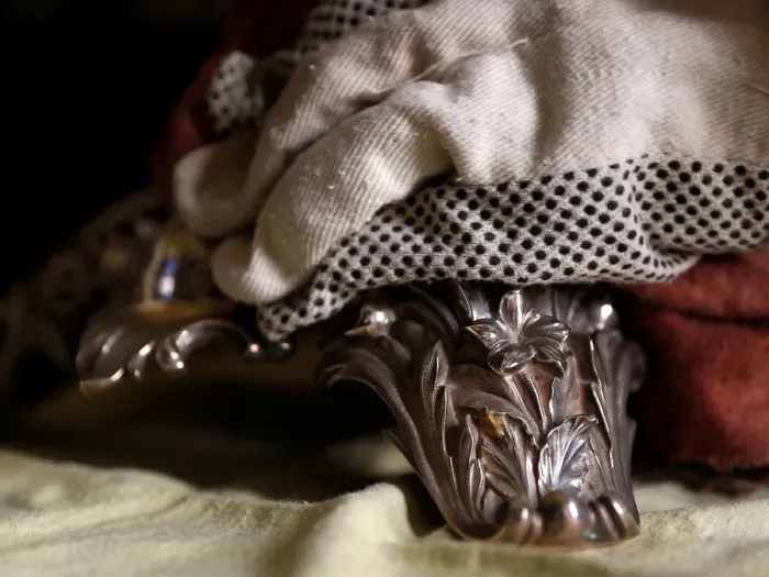 Framed Print : A woman polishes an antique silver candelabra at her home in Valletta