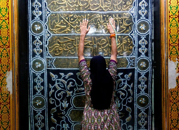 A woman prays at a shrine before breaking her fast during the holy month of Ramadan