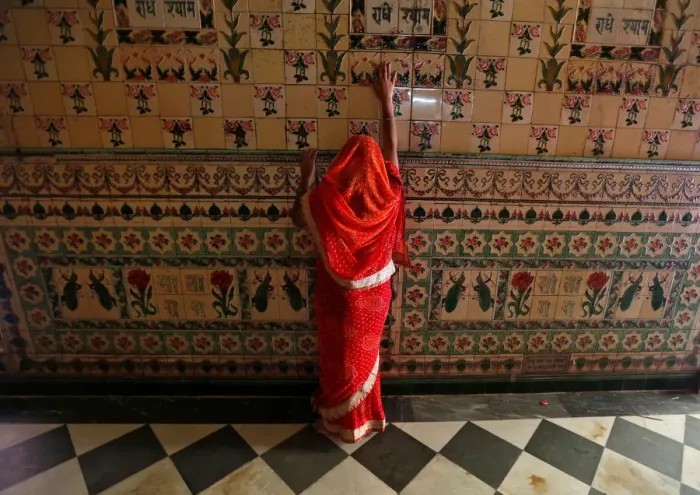 Framed Print : A woman prays as she touches the wall of a temple during Navratri festival in Kolkata Framed Print : A woman prays as she touches the wall of a temple during Navratri festival in Kolkata