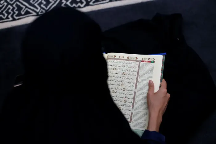 Framed Print : A woman reads Koran at a mosque in Jakarta Framed Print : A woman reads Koran at a mosque in Jakarta