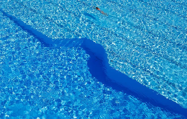 A woman swims in a public pool as temperatures reach new record highs in Hanau