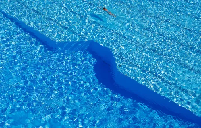 Framed Print : A woman swims in a public pool as temperatures reach new record highs in Hanau