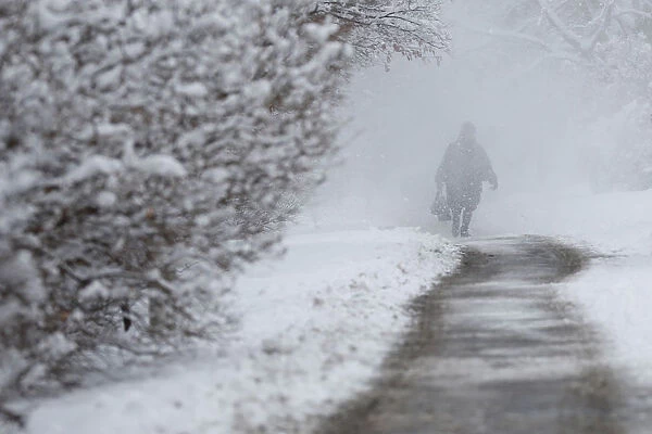 A woman walks through blowing snow along the Rideau Canal in Ottawa