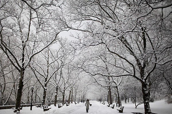 A woman walks on fresh snow in New York Citys Riverside Park