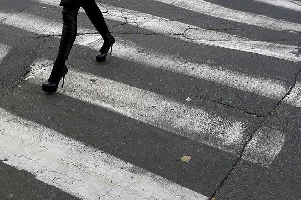 A woman walks down a pedestrian crossing in central Kiev