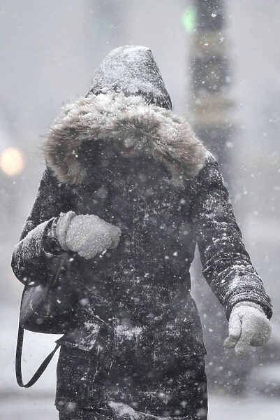 A woman walks through snow in London