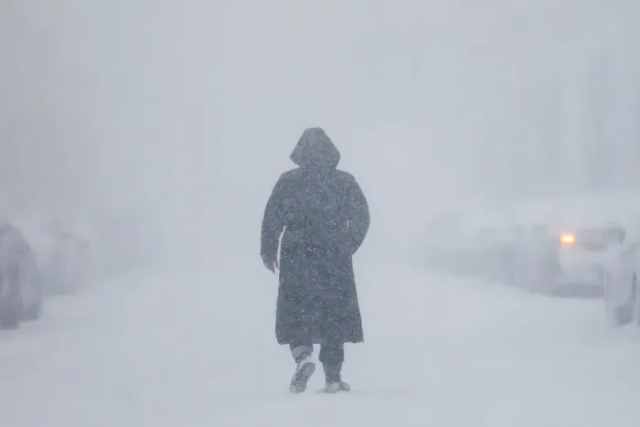 Framed Print : A woman walks down the street during a blizzard in Long Beach Framed Print : A woman walks down the street during a blizzard in Long Beach